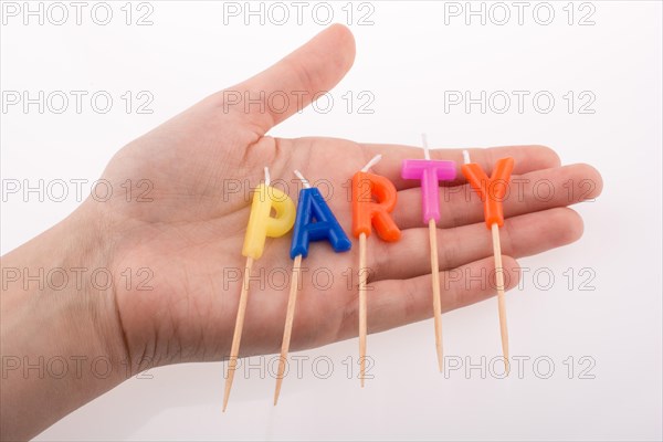 Color candles in hand on sticks write the word party