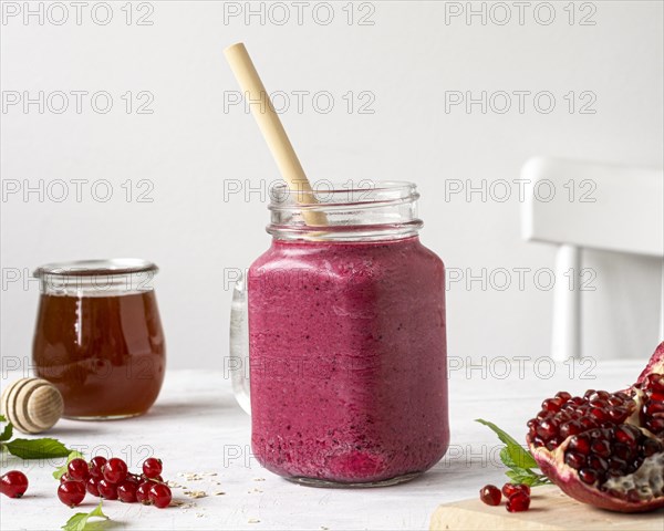 Delicious fruit smoothie with straw