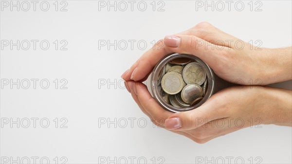 Person holding jar with coins