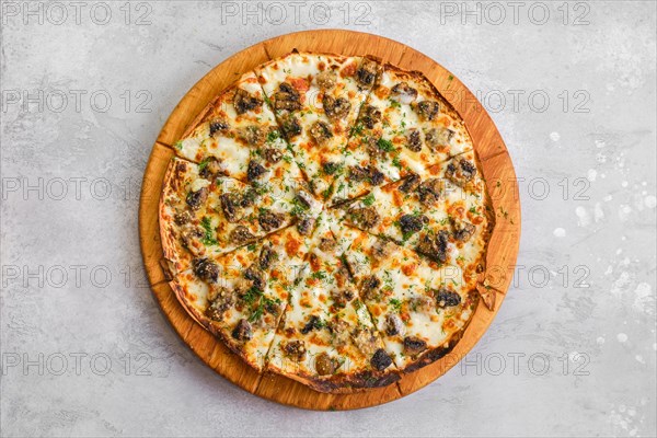 Thin-crust pizza dough with mushrooms and lot of melted cheese