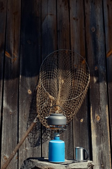 Boiling water in hiking kettle. Outdoor cooking equipment