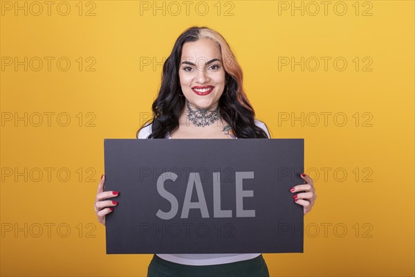 Beautiful woman holding a Sale sign. Commercial concept. Commerce