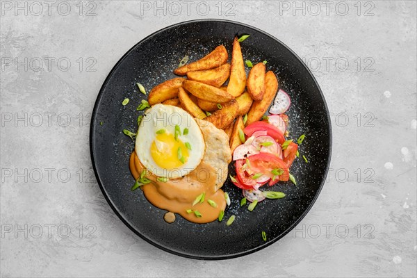 Top view of chopped pork sirloin with fried potato wedges