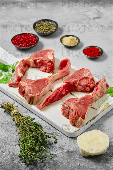 Raw boneless rack of lamb on wooden cutting board