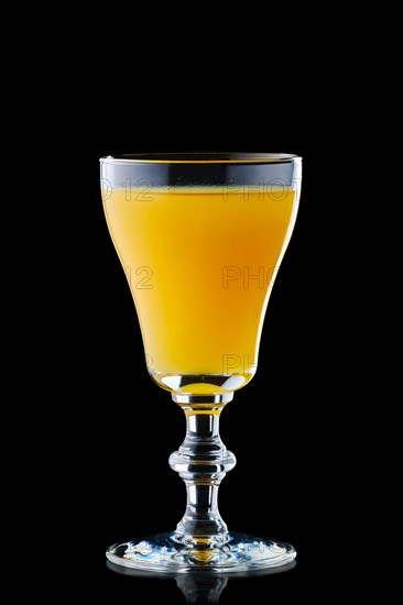 Glass with vodka and orange juice isolated on black background