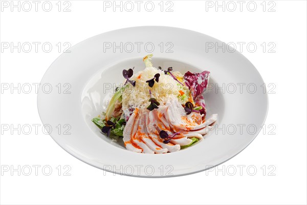 Salad with green and red cabbage and ham isolated on white background