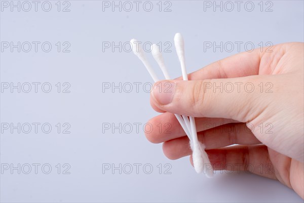 A few ear sticks in hand isolated on white background