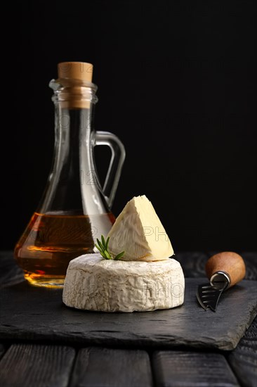 Brie cheese or camembert on stone board with knife for soft cheese