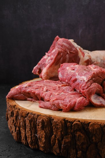 Chopped pieces of fresh lamb neck on cutting stump