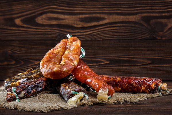 Variety of dried sausage on wooden table