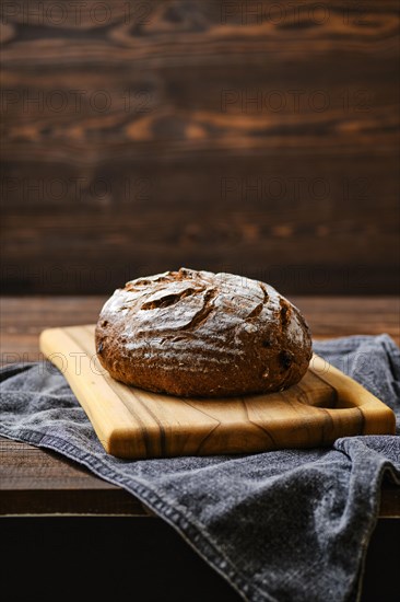 Fresh rye brown bread on wooden cutting board