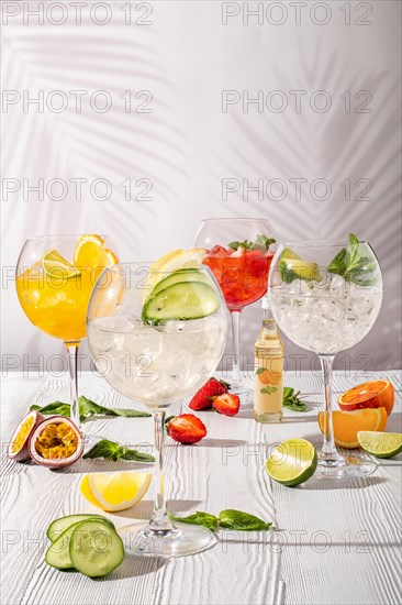 Cold sangria in wine glasses on white wooden table in morning sunlight