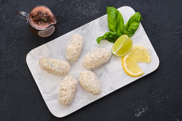 Top view of brown salmon meat cutlet in cheese breading