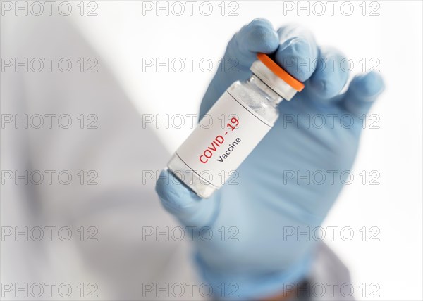 Close up doctor holding vaccine recipient her hand