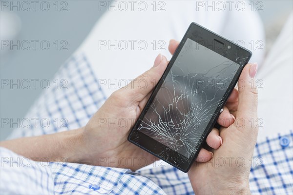 Overhead view woman holding broken mobile display screen. Resolution and high quality beautiful photo