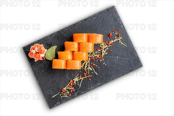 Set of rolls with wasabi and pickled ginger on stone serving board isolated on white