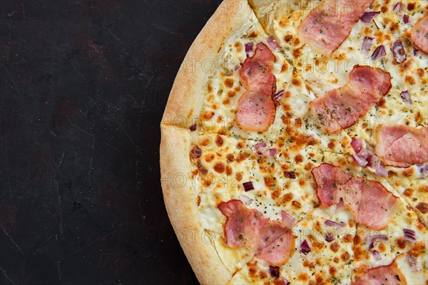 Close up view of pizza carbonara with bacon and onion