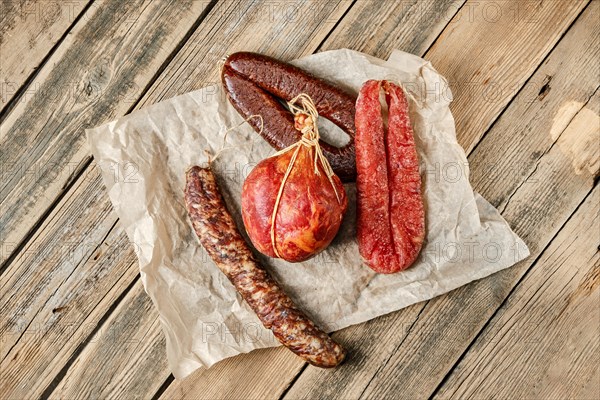 Top view of smoked dried sausages on wrapping paper