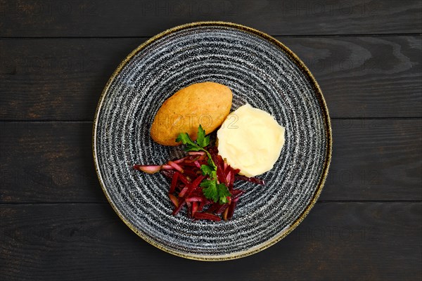 Top view of chicken cutlet stuffed with cheese served with millet porridge and pickled cabbage