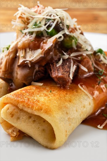 Macro photo of thin pancakes stuffed with beef and mushrooms