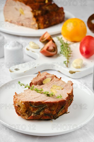 Closeup view of slice of roasted pork neck on a plate