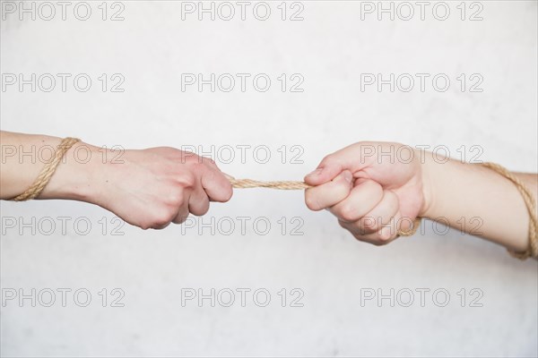 Hands pulling rope