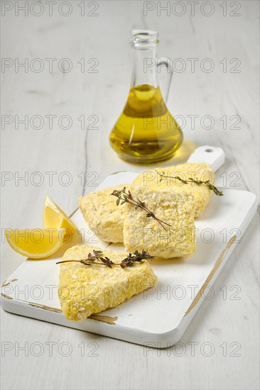 Semifinished frozen fish patty in breading for quick cooking