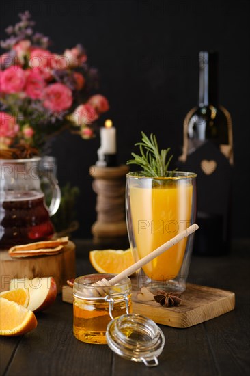 Composition with herbal and fruit hot alcohol drinks with ingredients on the table