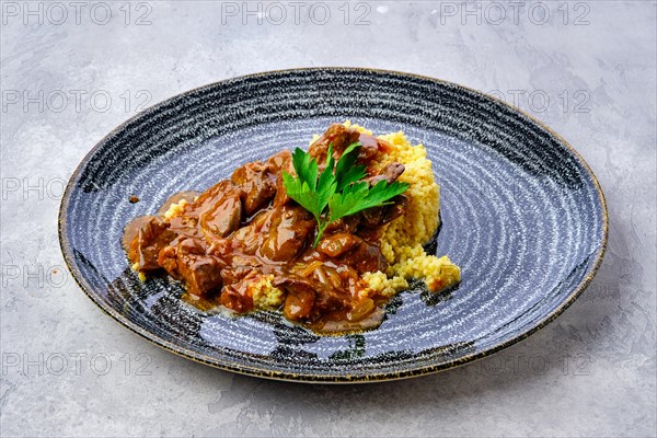 Beef goulash with millet porridge and creamy sauce