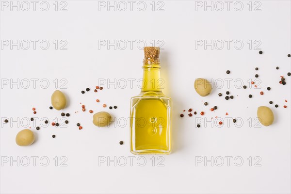 Olive oil with olives spices top view