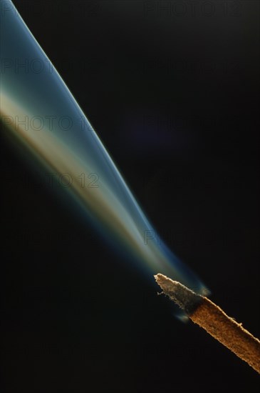 Trajectory of incense smoke in the air showing different shapes. France