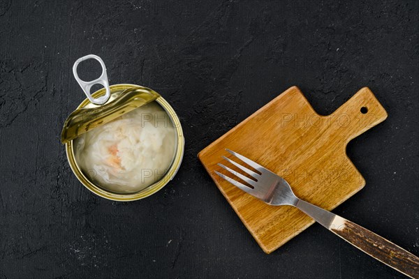 Top view of canned crab meat in open jar