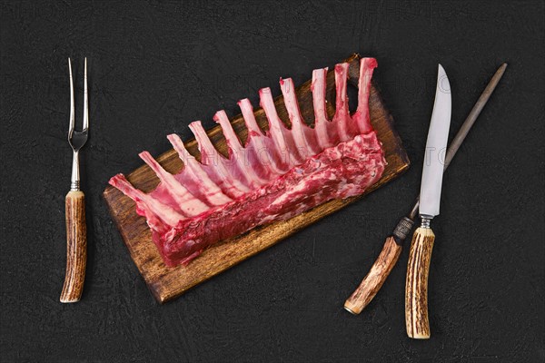 Overhead view of raw fresh rack of lamb on kitchen table