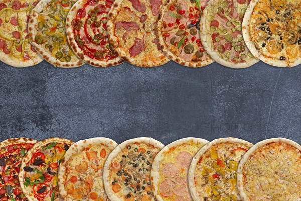 Horizontal collage of different baked pizzas on metal plate. Top view