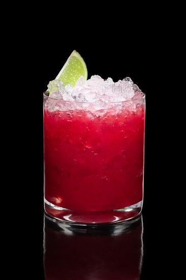 Cold strawberry cocktail with ice crush and lime