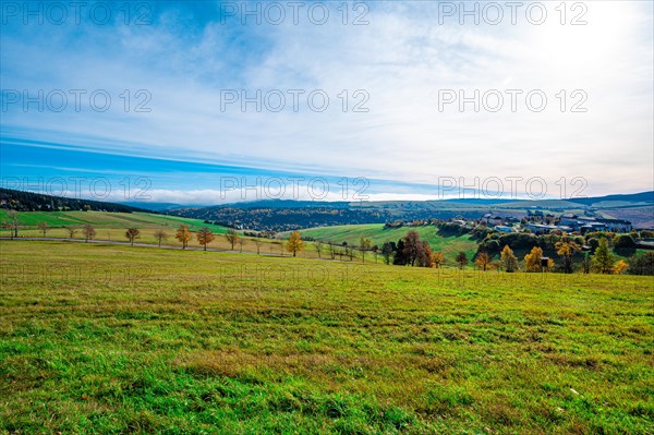 A meadow at the foot of the Fichtelberg with a view into the valley in autumn