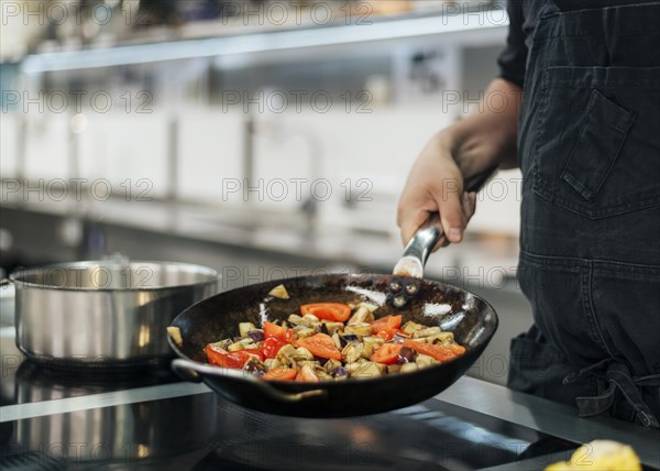 Chef with apron cooking dish kitchen