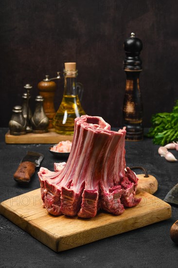 Closeup view of raw lamb ribs rolled in the shape of crown on the table