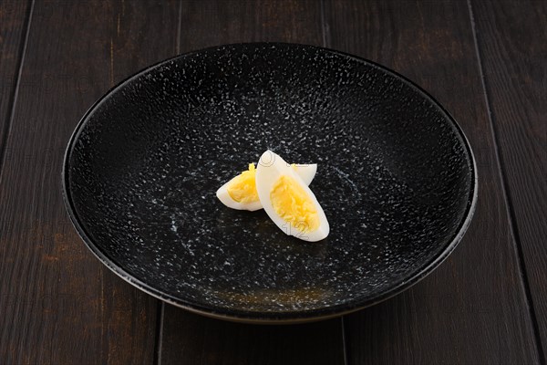 Half of boiled egg cut on two pieces on a plate