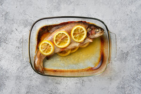 Top view of trout baked in oven in glass baking dish