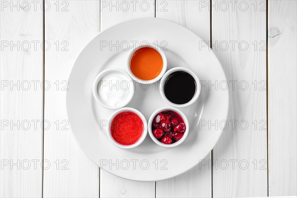 Assortment of different sauce on white wooden table