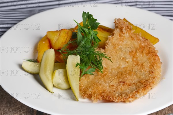 Chicken entrecote with potato and salty cucumber