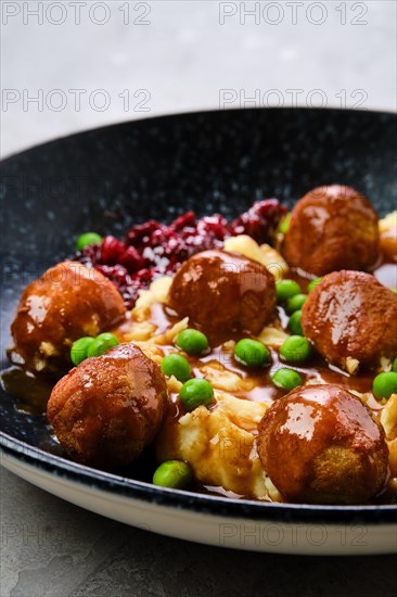 Closeup view of meatballs with gravy served with mashed potato