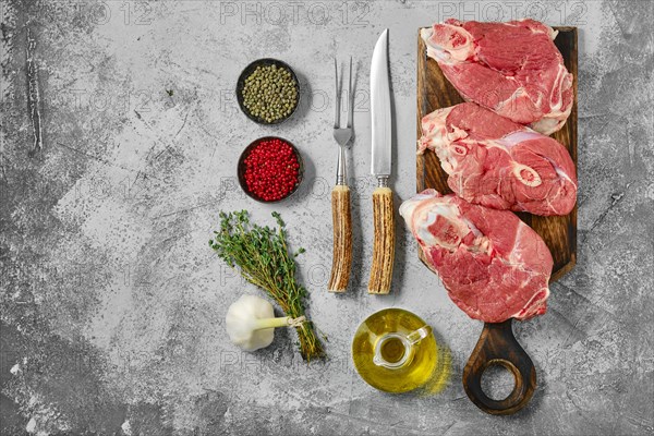 Top view of raw lamb leg cut as a steak. Slices of shank