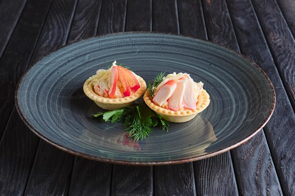 Appetizer for reception. Tartlet with cheese and crab meat