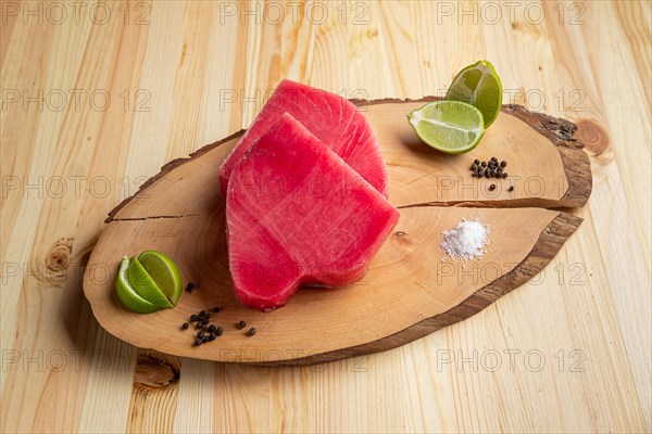 Fresh raw tuna steak on wooden cutting board