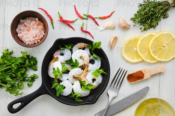 Top view of pan with fresh raw prawn with spice and herbs