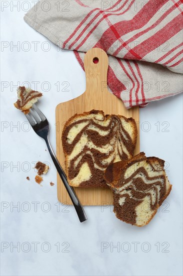 Marble cake on wooden board and fork