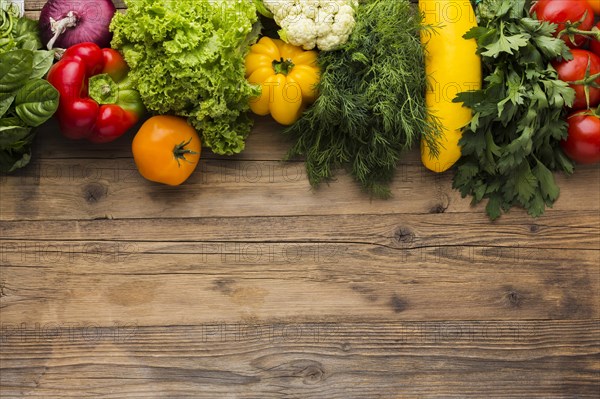 Flat lay vegetables assortment wooden background