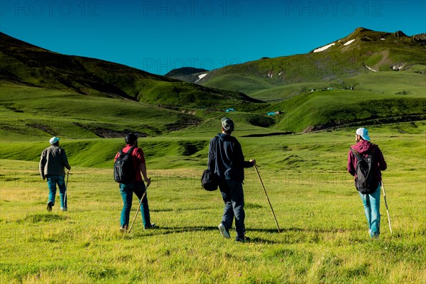 Hikers with backpacks and trekking poles walking in Turkish highland